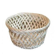 a white wicker basket with an intricate design on the bottom and sides, sitting in front of a white background