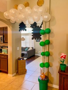 balloons are hanging from the ceiling in this living room