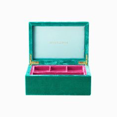 an open green box with two compartments and gold trimmings on the inside, in front of a white background