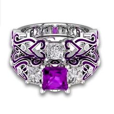 a purple and white ring with diamonds on it