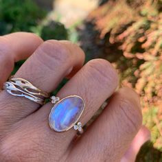 A stunning rainbow moonstone ensconced in 14k yellow gold is accented with petite white diamonds is set atop a sterling silver seagrass band. Approximate center stone size: 17mm x 10mm Approx Ct weight: 6.9 ct Mohs Hardness: 6-6.5 This one of a kind piece is handmade in Emily's Hudson Valley studio. If you have questions about sizing, shipping or need help deciding please reach out to us! Luxury Yellow Gold Moonstone Ring For Formal Occasions, Luxury Fusion Style Moonstone Ring For Anniversary, Luxury Dainty Moonstone Ring For Anniversary, Luxury Open Moonstone Ring For Wedding, Luxury Elegant Moonstone Ring For Anniversary, Luxury Gold Moonstone Ring For Anniversary, Stacked Engagement Ring, Birthstone Stacking Rings, Moonstone Engagement Ring