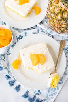 two plates with slices of pineapple cake on them next to a bowl of fruit