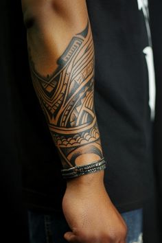 Intricate tribal tattoo on a person's forearm. Wrist Tattoos For Guys