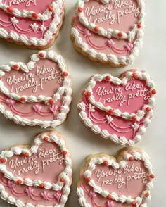 heart shaped cookies with writing on them that say, you're pretty please party