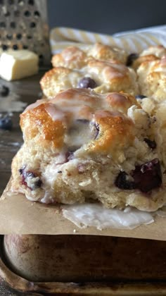 two blueberry scones sitting on top of a cutting board