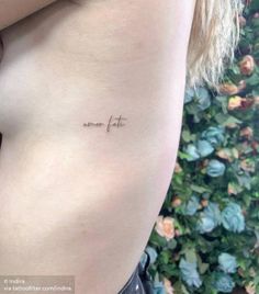 the back of a woman's stomach with an inscription on it