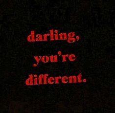 the words daring, you're different are lit up in red on a black background