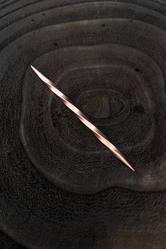 a close up of a metal object with a long knife sticking out of it's center