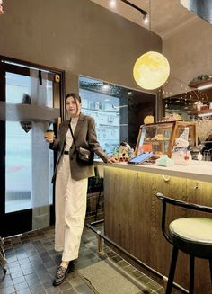 a woman standing in front of a counter