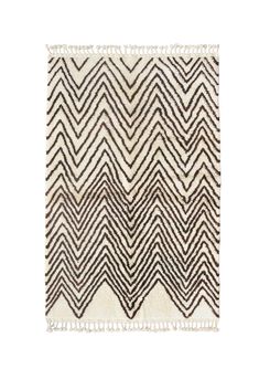 a black and white rug with fringes on the bottom, in front of a white background