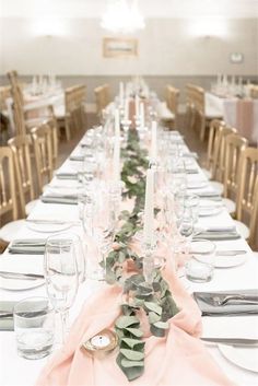 the table is set with white and pink linens