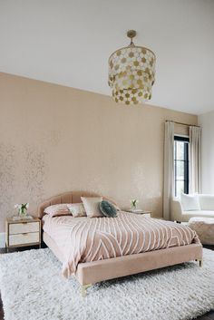 a bed room with a neatly made bed next to a window and a rug on the floor