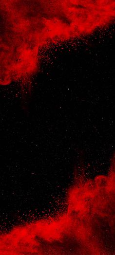 an abstract red and black background with small speckles on the bottom right corner