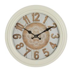 a white clock with brown numbers on it