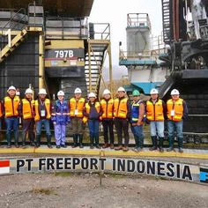 a group of people in safety vests standing next to each other