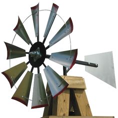 a metal windmill sitting on top of a wooden stand