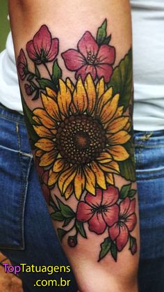 a woman's arm with a sunflower and flowers on it