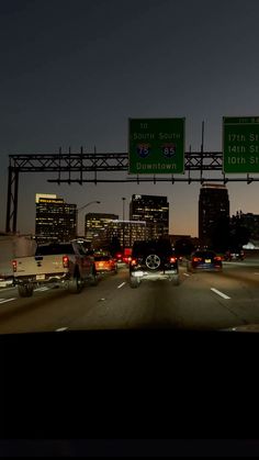 cars are driving down the highway at night