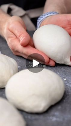 the person is kneading dough into balls