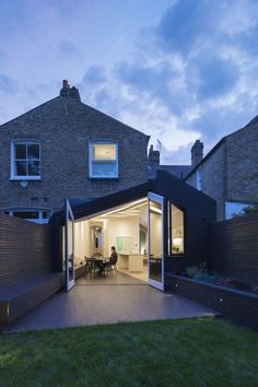 an open patio area in front of a brick house