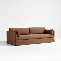 a brown couch sitting on top of a white floor