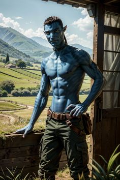 a man with blue paint on his face and chest standing in front of a wooden structure