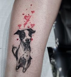 a small dog tattoo on the right forearm and leg, with hearts flying above it