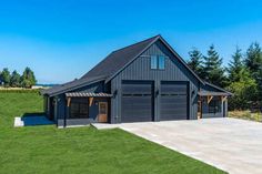 a large garage sits in the middle of a grassy field