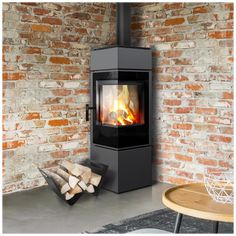 a wood burning stove in a room with brick walls