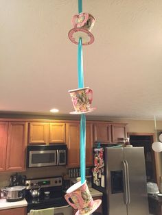 teacups hanging from the ceiling in a kitchen