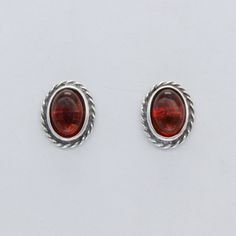 These is a pair of beautiful BALTIC AMBER Earrings from Gdańsk / Danzig, Poland. The earrings are made out of solid 925 Silver and there is no nickel or other substances causing most allergies. This makes the earrings hypo allergenic. Size of one Earring 1.0 x 0.8 cm or  0.39 x 0.31 inch Please note: Our jewelry is photographed close up to show detail and may appear larger than they are. We are happy to help with any questions. You will receive the item in a gift box - perfect to surprise someon Formal Silver Oval Cabochon Earrings, Polished Oval Clip-on Earrings, Lapis Jewelry, Amber Earrings, Handcrafted Artisan Jewelry, Ancient Jewelry, Gdansk, Lovely Earrings, Baltic Amber