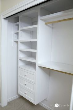 an empty closet with white shelves and drawers