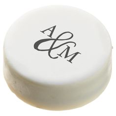 a white round object with black letters on the top and bottom, sitting in front of a white background