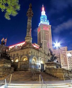 a large building with a clock tower in the background and stairs leading up to it