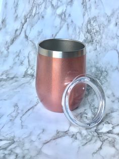 a cup with a lid sitting on top of a marble counter