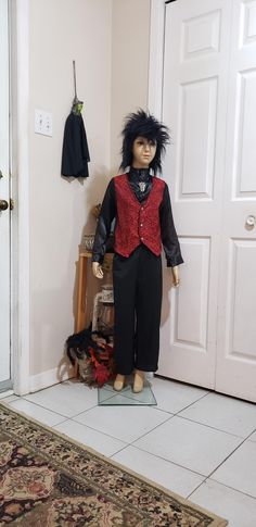 a doll is standing in front of a door