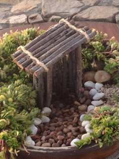 a bird house made out of wood and rocks