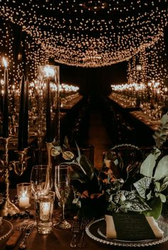 a table topped with lots of candles and flowers