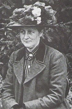 an old photo of a woman wearing a hat