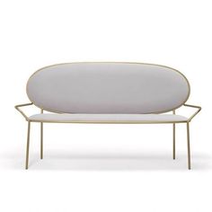 a white couch with gold trimmings on the back and arms, sitting in front of