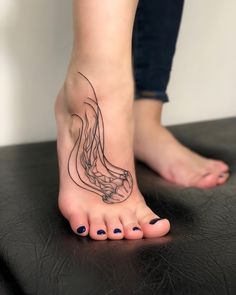 a woman's foot with a tattoo on it