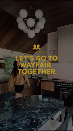 a woman standing in front of a kitchen counter with the words let's go to wayfair together