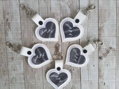 four heart shaped keychains with pictures on them