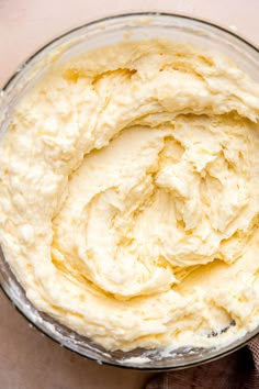 a bowl filled with cream sitting on top of a table