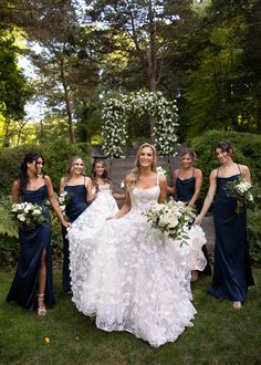 a bride and her bridal party posing for a photo