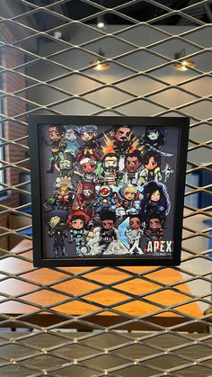 a bunch of anime characters are hanging on the wall behind a metal caged area