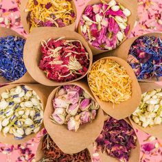 several bowls filled with different types of flowers