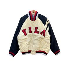 DESCRIPTIONS & MEASUREMENTS TAG BRAND : FILA MADE : CHINA SIZE ON TAG : M (Please check the actual measurements below) PIT TO PIT : 24.5 INCH LENGTH : 27.5 INCH SLEEVE LENGHT : 24 INCH CONDITION : Good Condition 8/10 Measurement manual (when laid on floor) PAYMENT  : PAYPAL ONLY Please DROP your PHONE NUMBER after purchase for the delivery process. ATTENTION   Please pay close to measurement provided. Do not rely on tag size. The best way to ensure fits is compare with measurement of item that you usually wear. Enlarge the photo for clearer image.  Thank you... Sporty Cotton Varsity Jacket With Embroidered Logo, White Varsity Jacket With Embroidered Logo For Streetwear, Crew Neck Varsity Jacket With Embroidered Logo For Streetwear, Casual Track Jacket With Embroidered Logo For Streetwear, Sporty College Outerwear With Logo Print, Retro Sports Varsity Jacket With Graphic Print, Retro Graphic Print Varsity Jacket For Sports, Retro Varsity Jacket With Graphic Print For Sports, Retro White Varsity Jacket With Letter Print