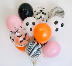 a bunch of balloons with faces on them