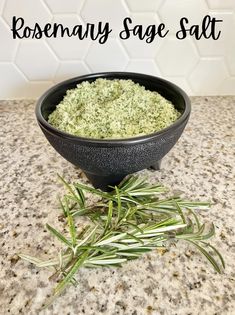 rosemary sage salt in a black bowl on a marble counter top with the words rosemary sage salt